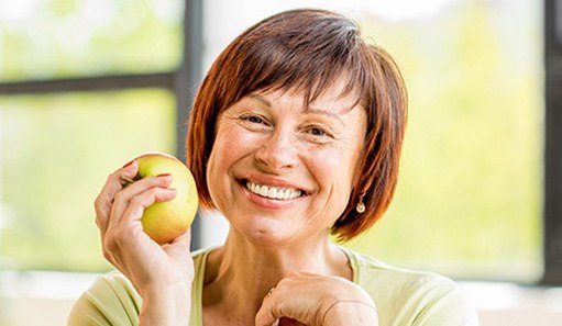 A photo highlighting a bearded man’s front-facing dental implant