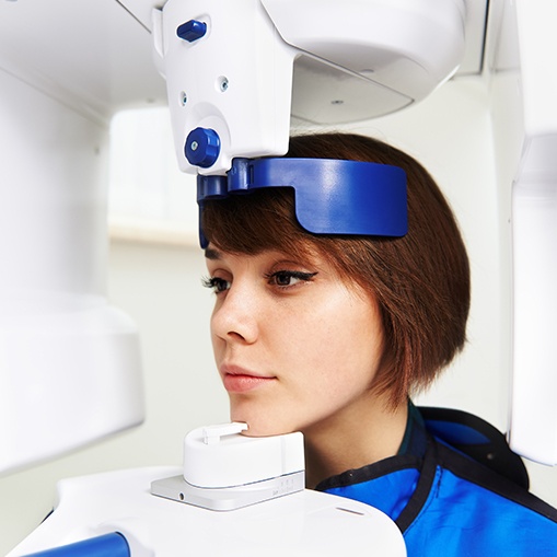 Woman receiving 3 D C T cone beam dental x-ray scan