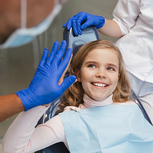 Little girl giving dentist a high five