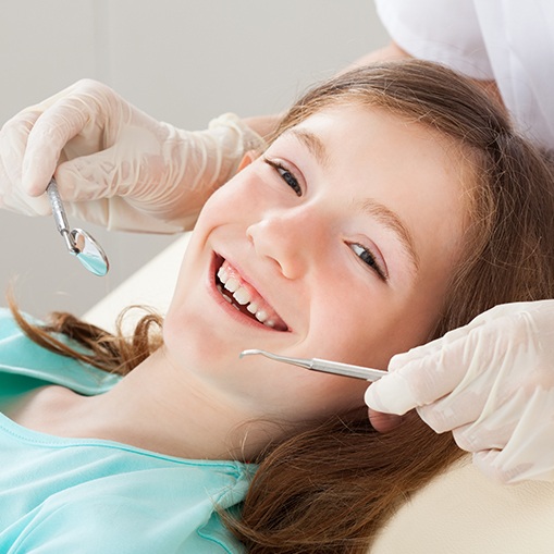 Young girl receiving dental checkup and teeth cleaning