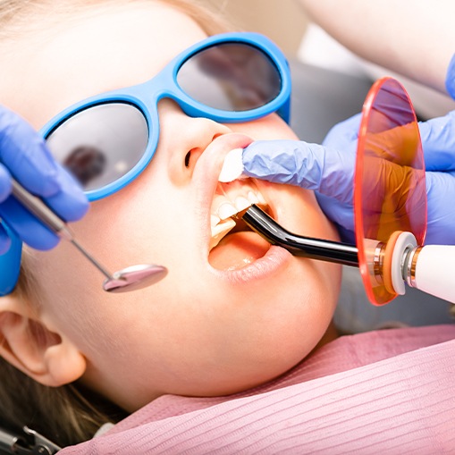 Child receiving dental sealants