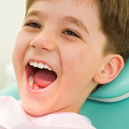 Little boy laughing after receiving tooth colored filling