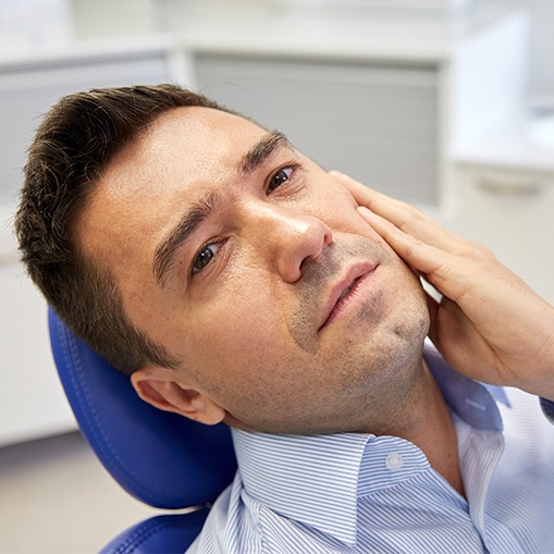 Man in pain holding his jaw