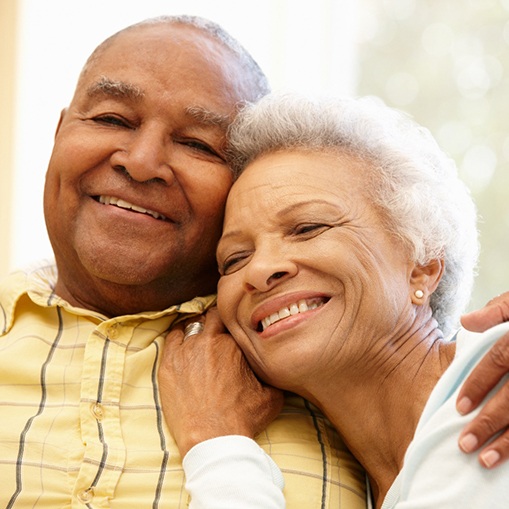 smiling couple who have dental implants in Oshkosh