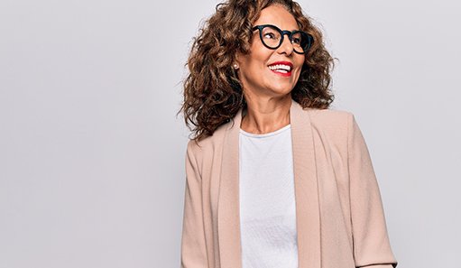 woman smiling and looking to the side with dental implants in Oshkosh