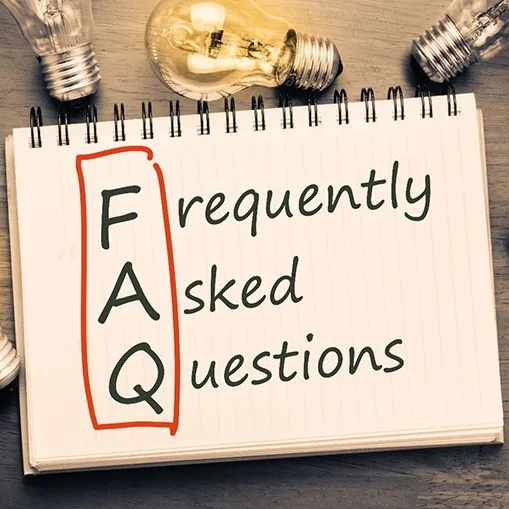 Lightbulbs around notepad with words frequently asked questions