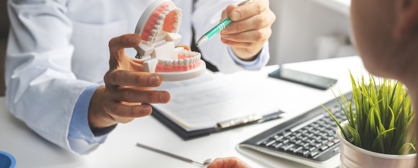 Dentist pointing to smile model