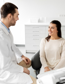 Dentist discussing cosmetic dentistry options with dental patient