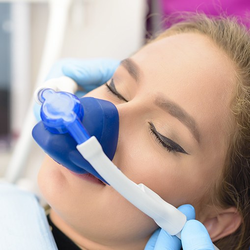 Woman with nitrous oxide sedation dentistry mask in place