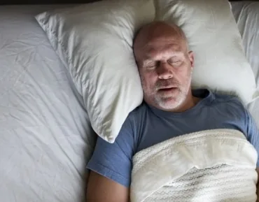 Man sleeping soundly thanks to sleep apnea therapy