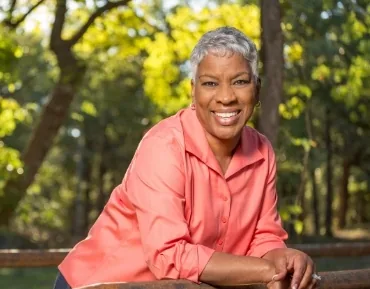 Smiling woman outdoors after restorative dentistry treatment