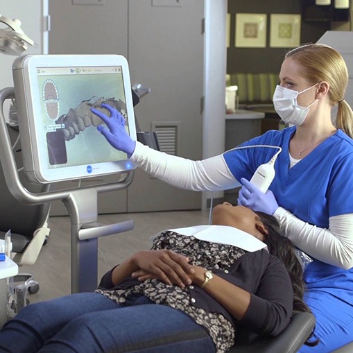 Dentist and patient looking at iTero digital impressions