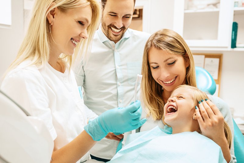 Family smiling at routine dental appointment