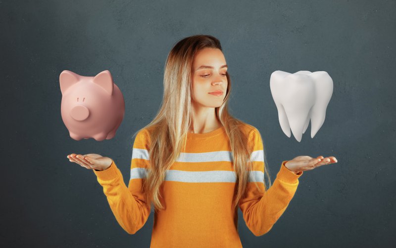 Woman choosing between piggy bank and dental care