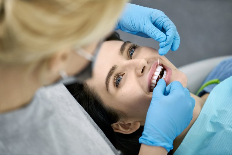 a woman undergoes a regular dental checkup and cleaning at the start of the new year