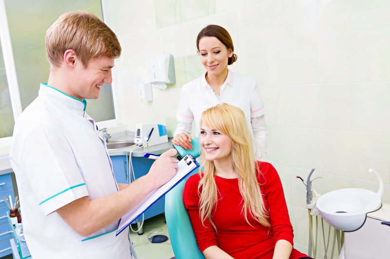 a young female listening to her dentist in Oshkosh and preparing to ask a few questions 