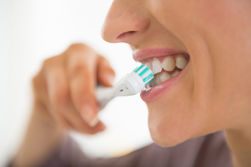 young woman brushing teeth