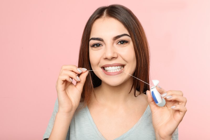 young woman flossing