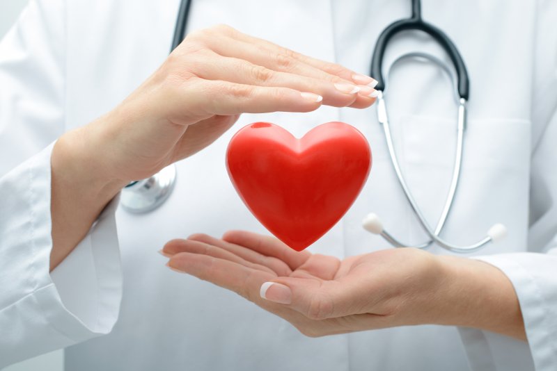 doctor holding floating heart in hands