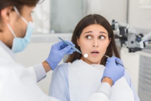 woman looking scared at dentist 