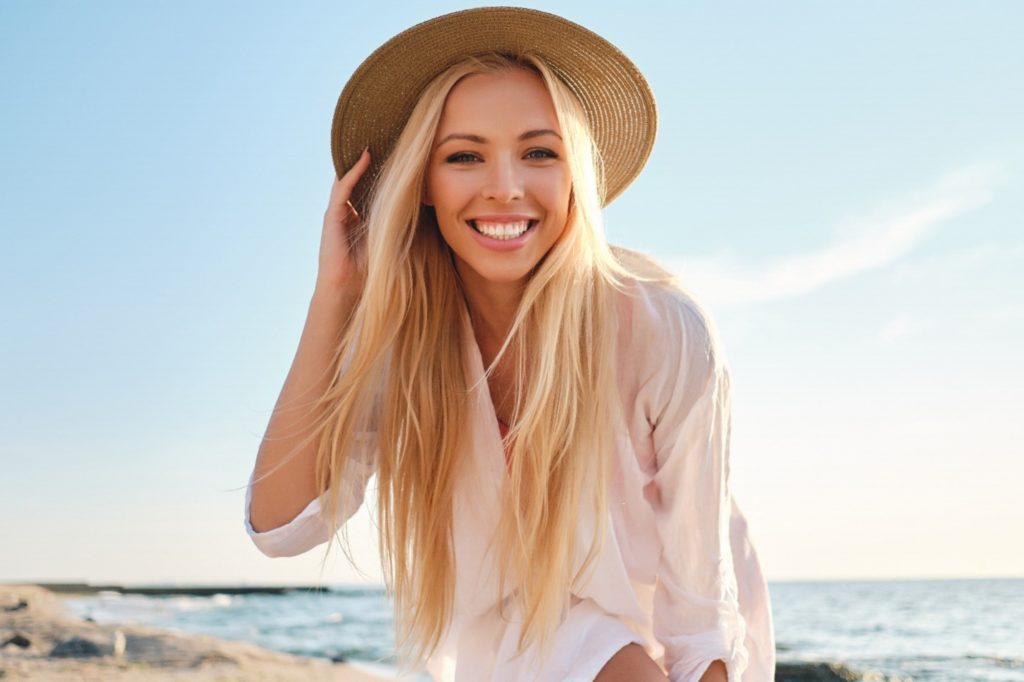 Smiling woman at the beach.