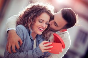 a couple exchanging smile-friendly gifts for Valentine’s Day