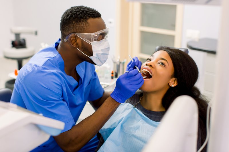 dentist helping a patient during a checkup