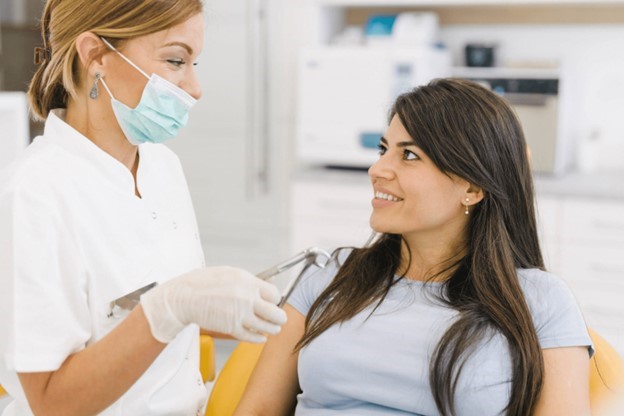 person smiling while talking to dentist