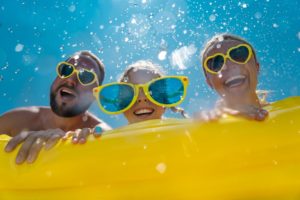 family enjoying summer vacation in the water