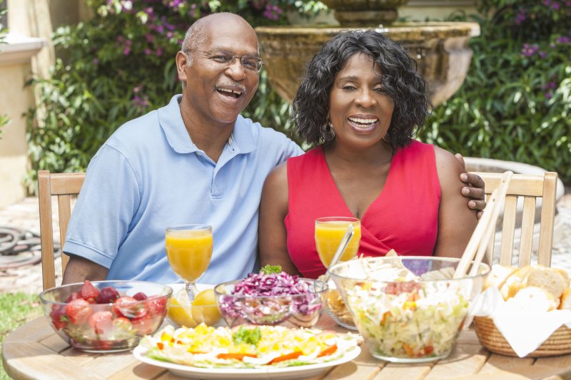 Older couple sitting at a table full of food