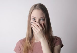 Woman covering her mouth with her hand