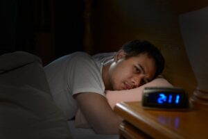 Man suffering through sleepless night.